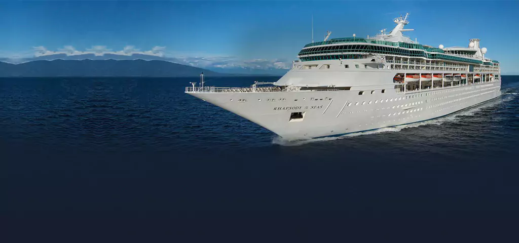 Rhapsody of the Seas cruise ship on clear blue ocean, a luxury voyage often featured by travel company in kolkata.