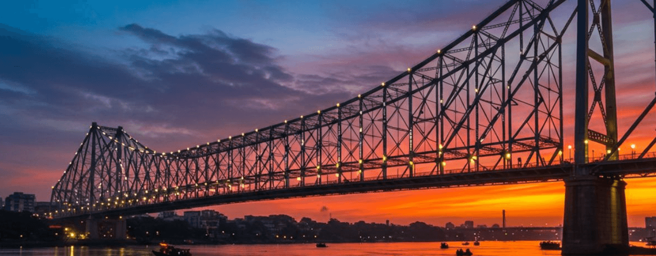 HOWRAH BRIDGE -famous for its immense size, construction without nuts or bolts|SIGHTSEEING OFFERED BY TOUR COMPANY OF KOLKATA