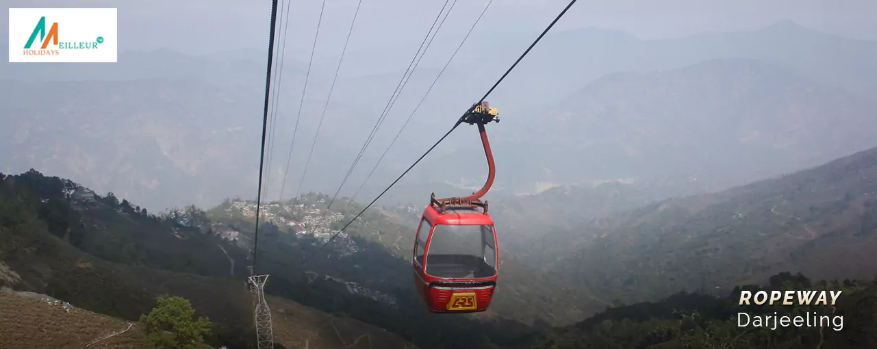A red cable car on Darjeeling’s ropeway, offering scenic views of misty mountains. Experience this on a Darjeeling tour package from Kolkata.