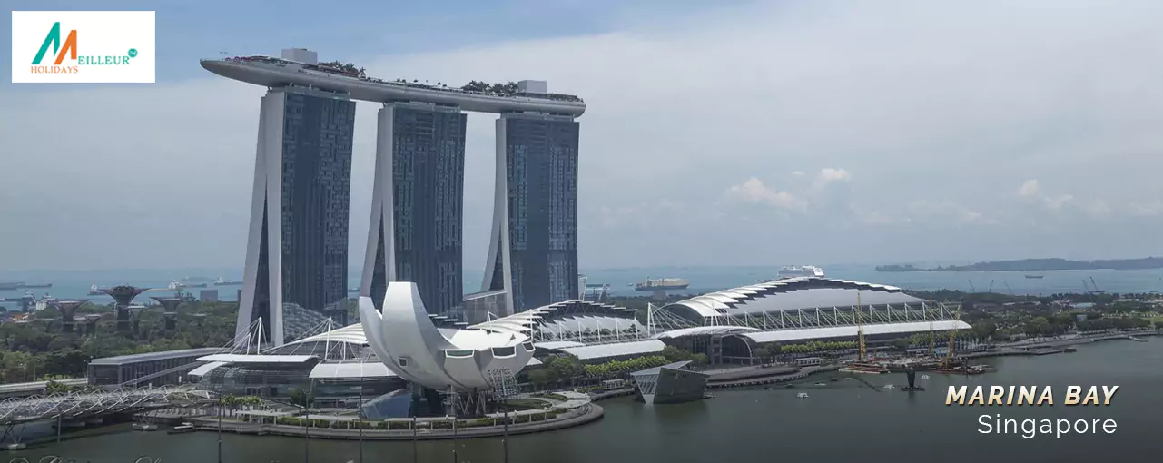 Iconic Marina Bay Sands hotel & ArtScience Museum against a cloudy backdrop - part of the Singapore Malaysia Tour Package.