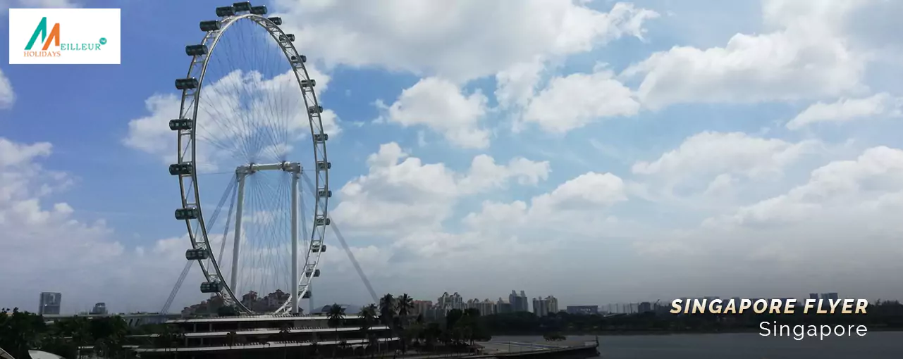 The Singapore Flyer stands tall against a picturesque skyline, a highlight of the Singapore cruise package.