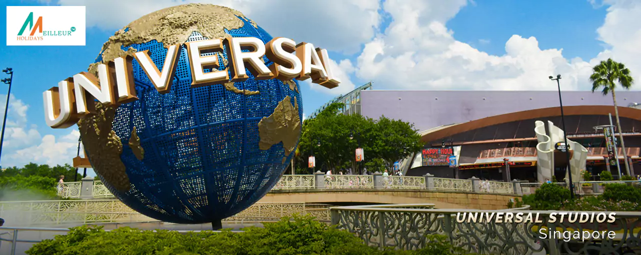 Outside Universal Studios Singapore, a globe stands amidst greenery, part of a Singapore tour package with cruise.